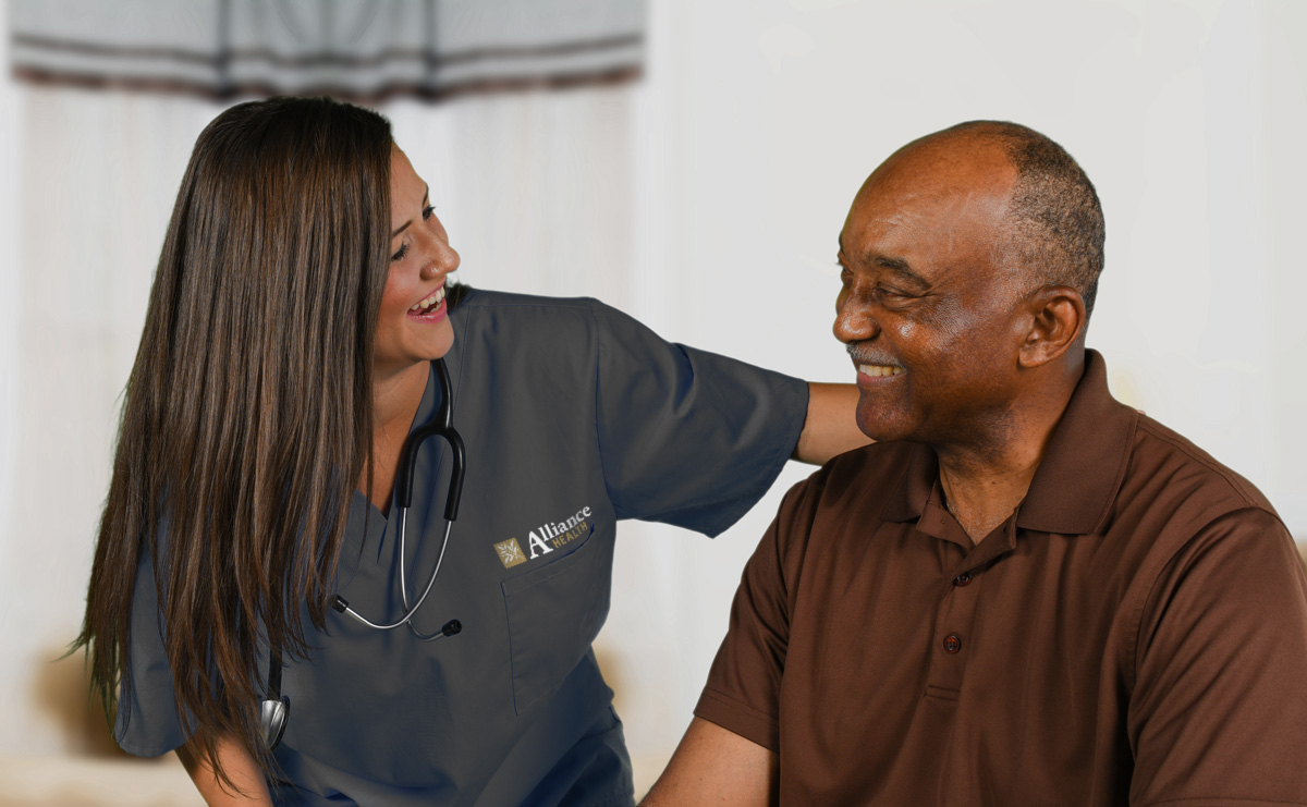 nurse helping elderly man